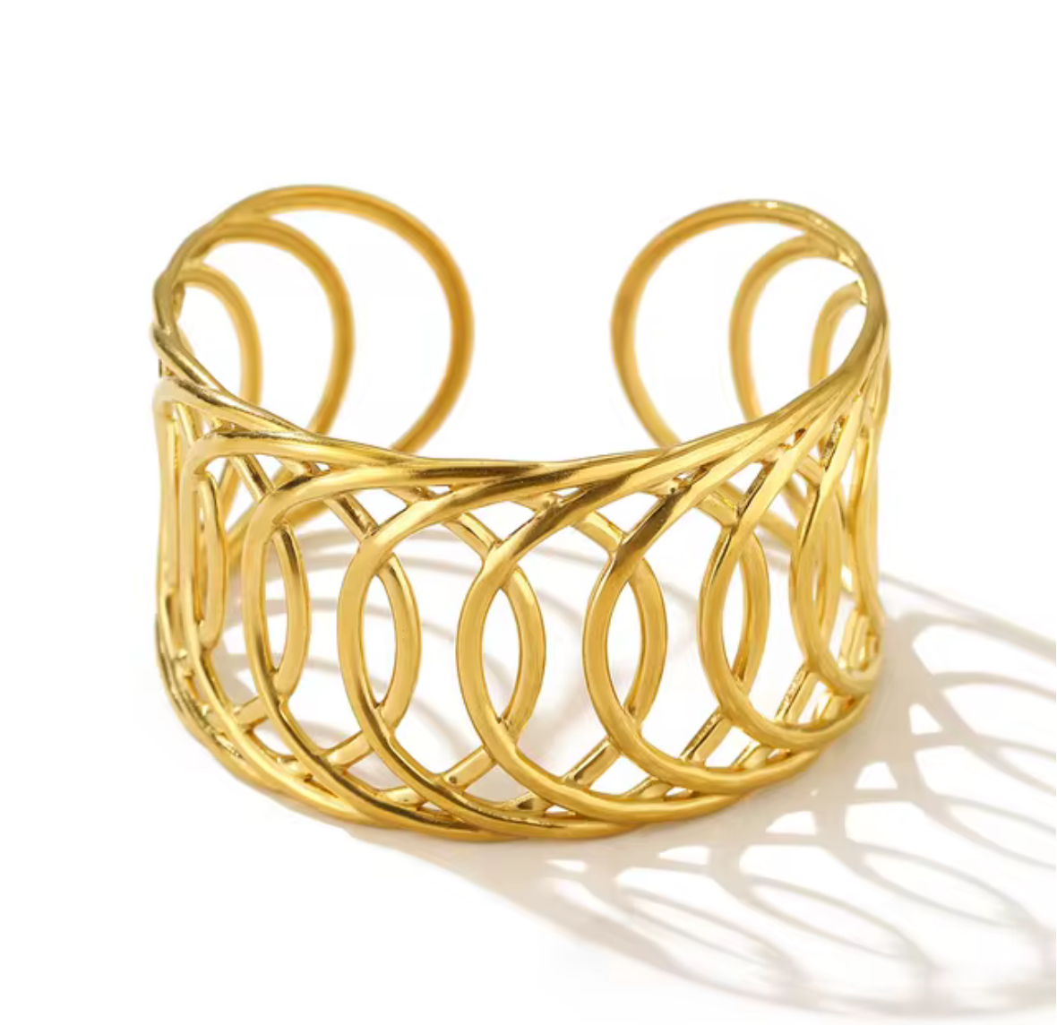 Gold cuff bracelet on a white background
