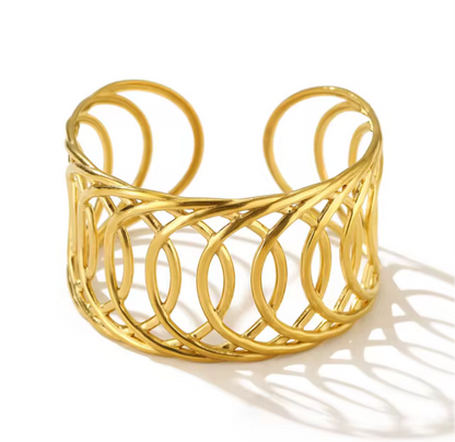 Gold cuff bracelet on a white background