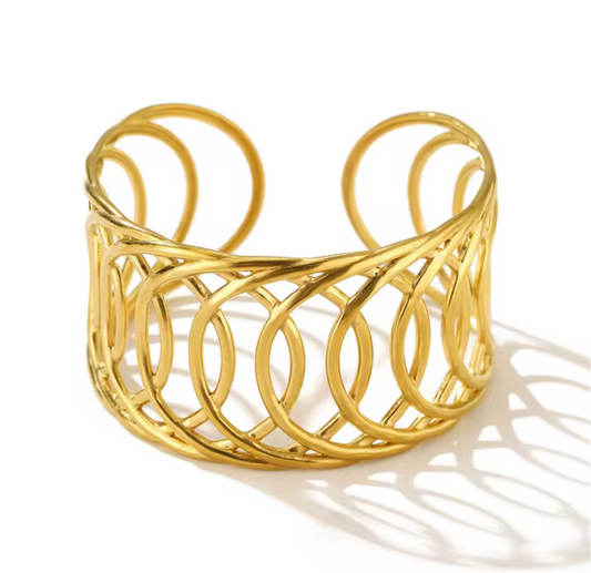 Gold cuff bracelet on a white background